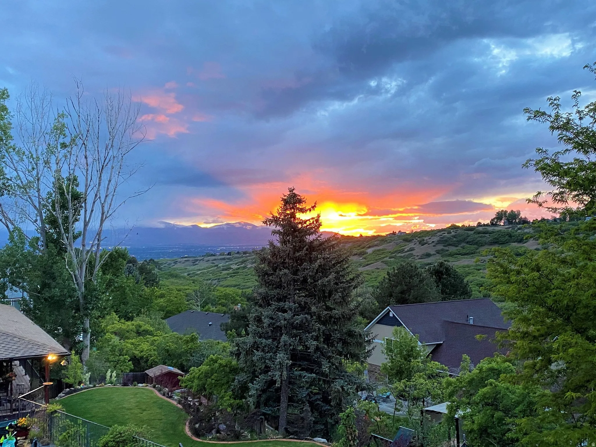 Expansive landscape featuring distant mountains and a vibrant sky