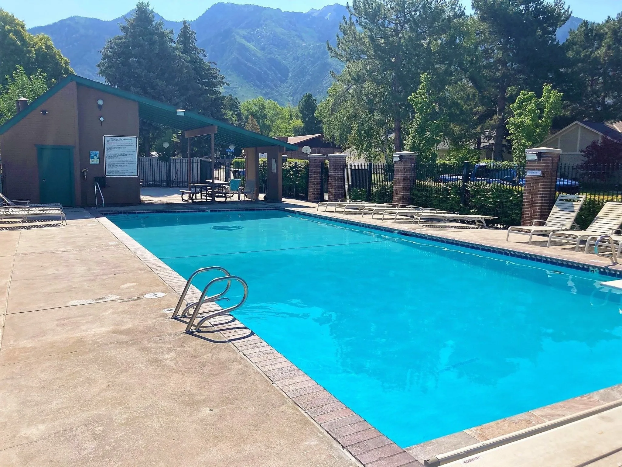 Rectangular swimming pool with concrete decking and brick coping