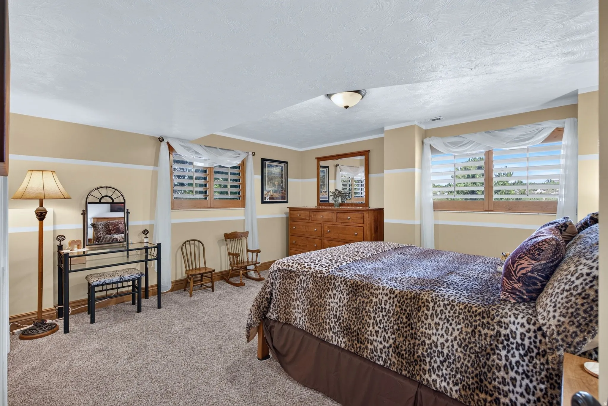 Carpeted interior space featuring light beige walls with white trim