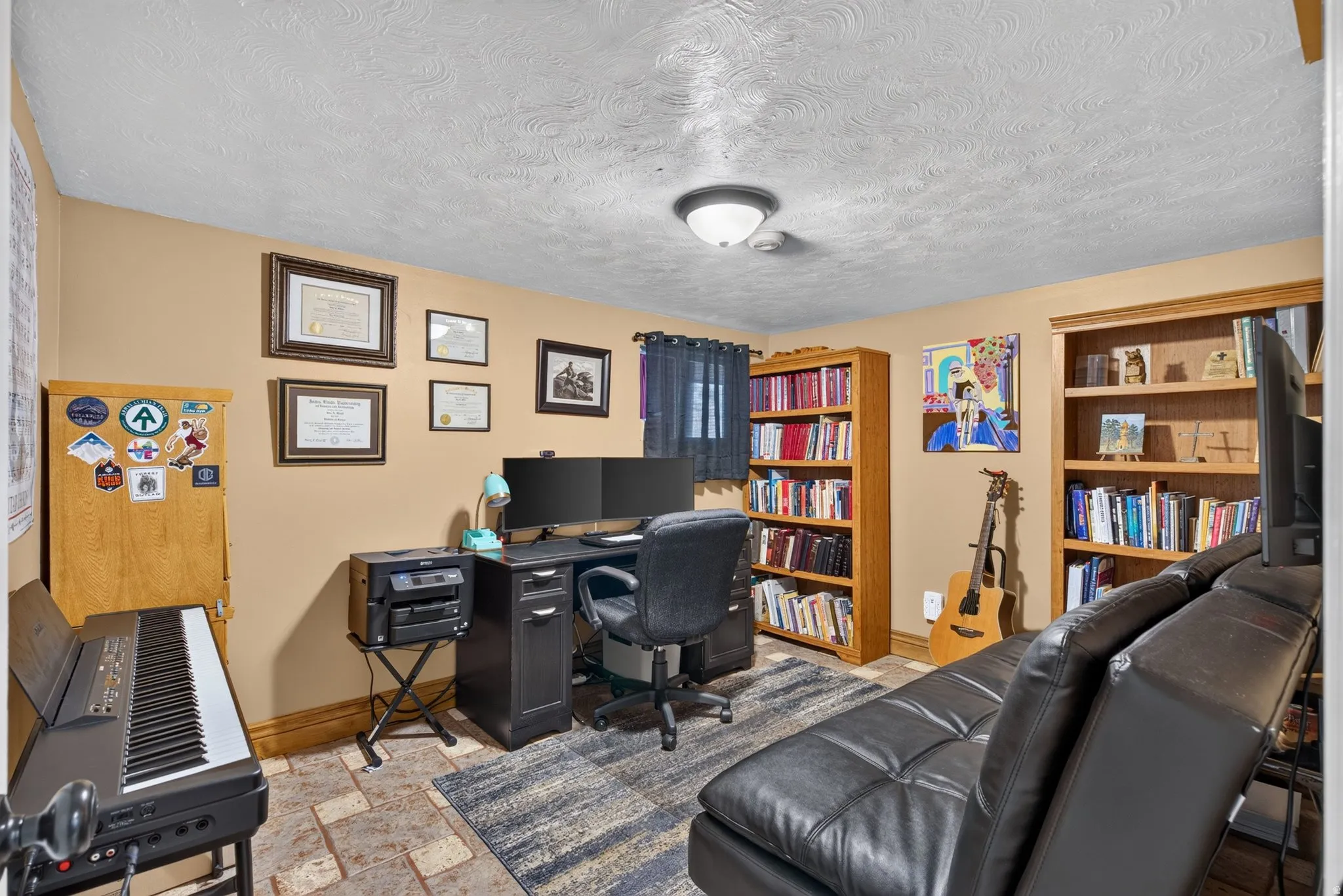 Room with neutral wall paint and textured ceiling