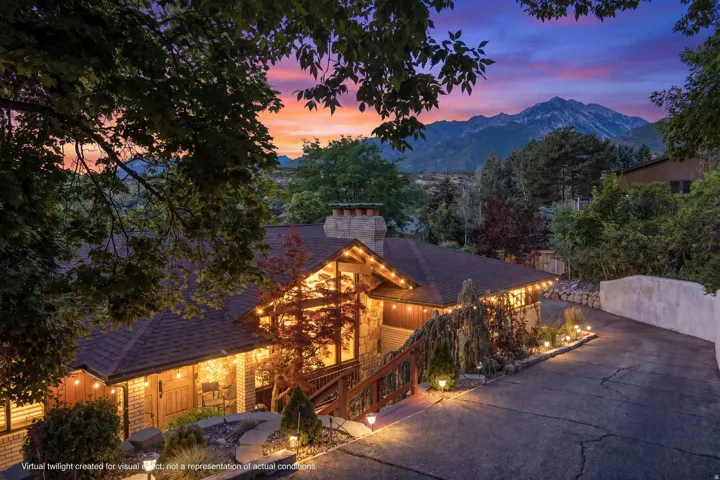 Stone and wood-sided exterior featuring a multi-level roofline, prominent chimney, and integrated outdoor lighting