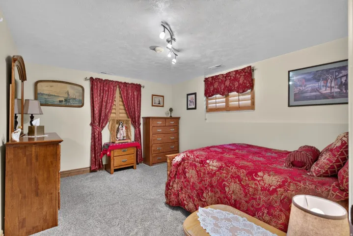 Wall-to-wall carpeting in a neutral tone complements the light-colored walls