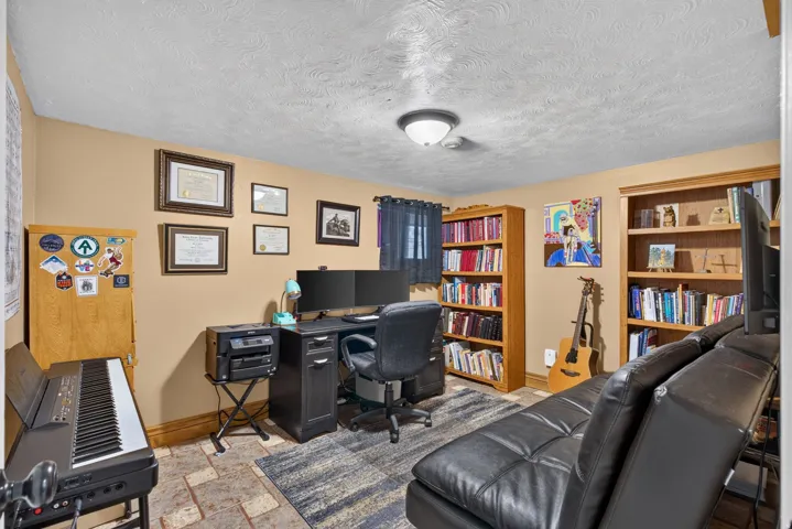 Room with neutral wall paint and textured ceiling