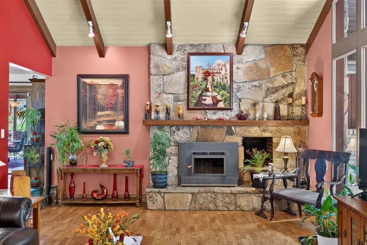 Stone fireplace with hearth and wood-burning insert