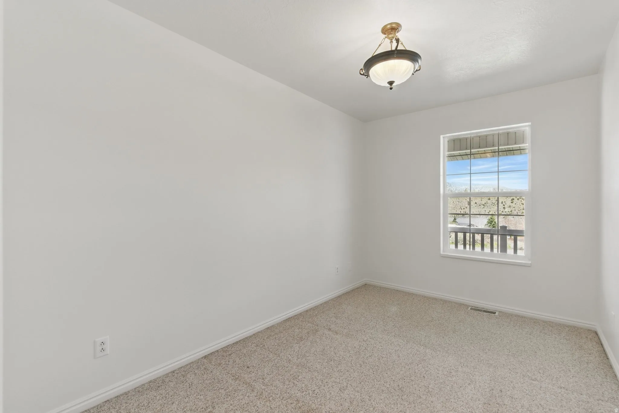 Room featuring light-colored carpeting, white baseboards, and a single window with white trim