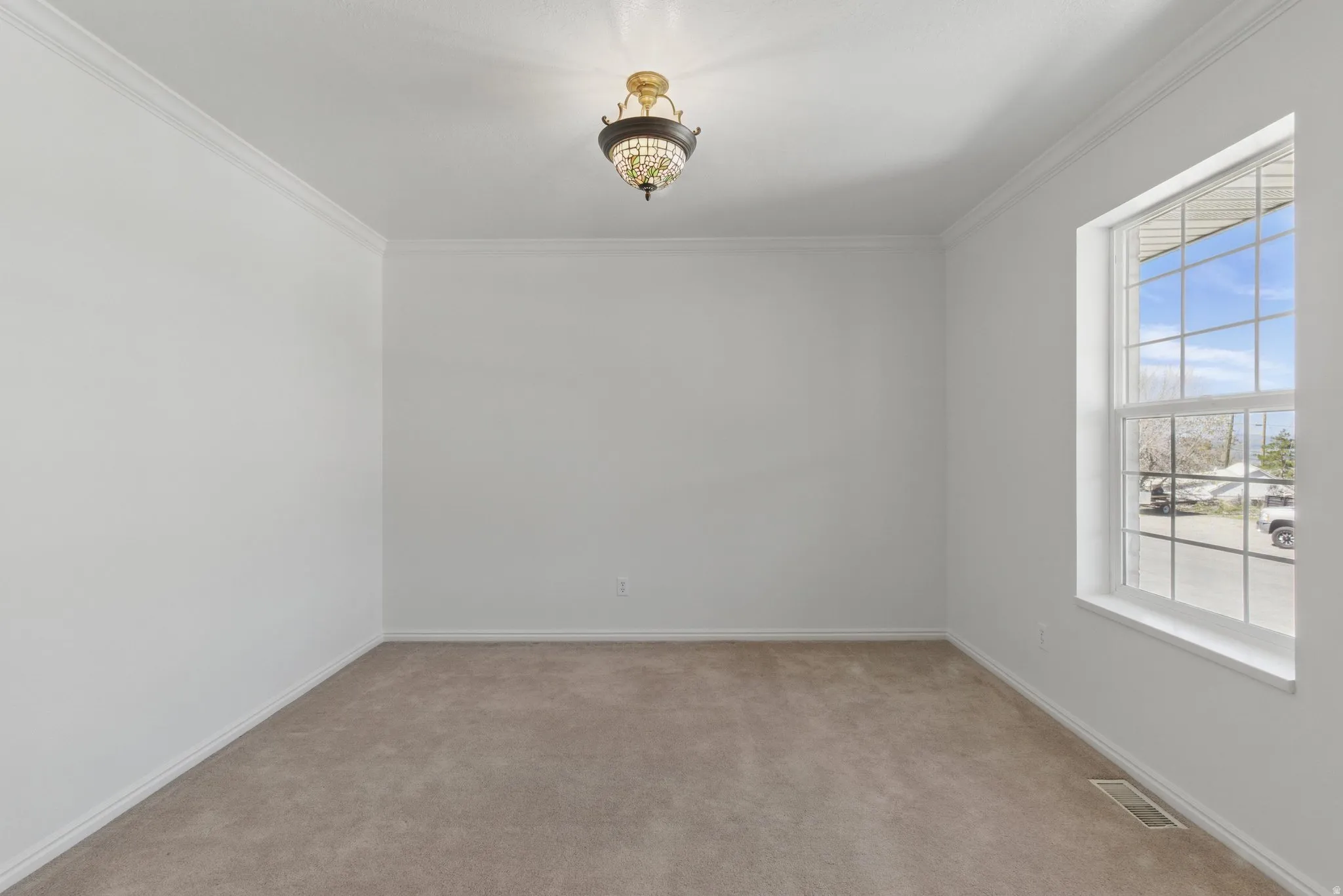Neutral-toned wall finishes with crown molding and baseboards