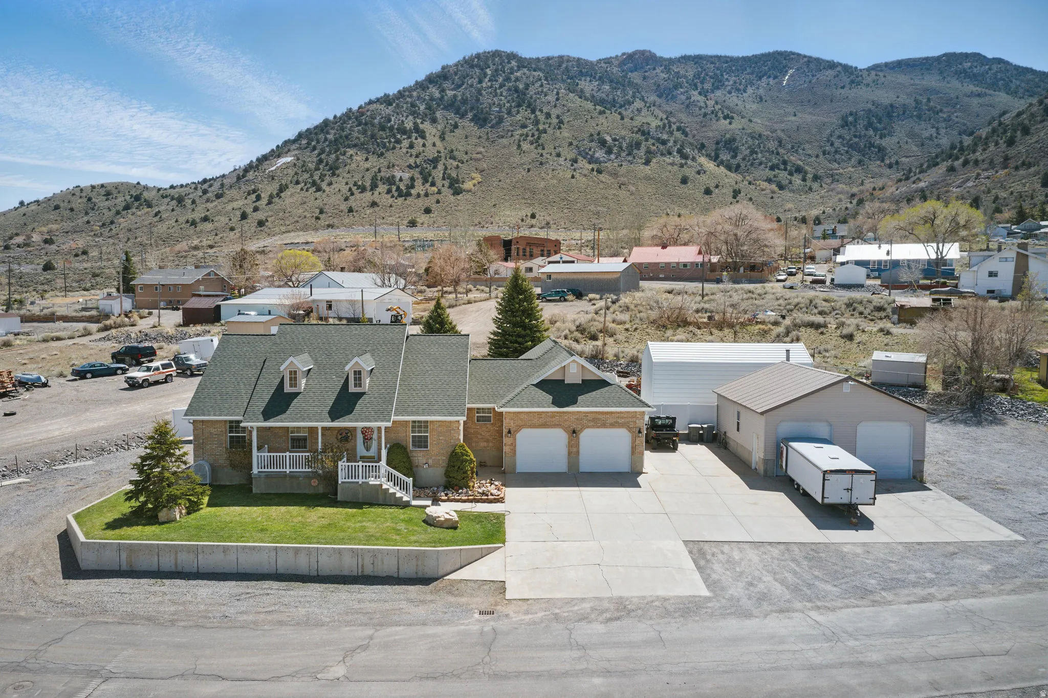 Single-family residence featuring a dormer roof and a stone facade