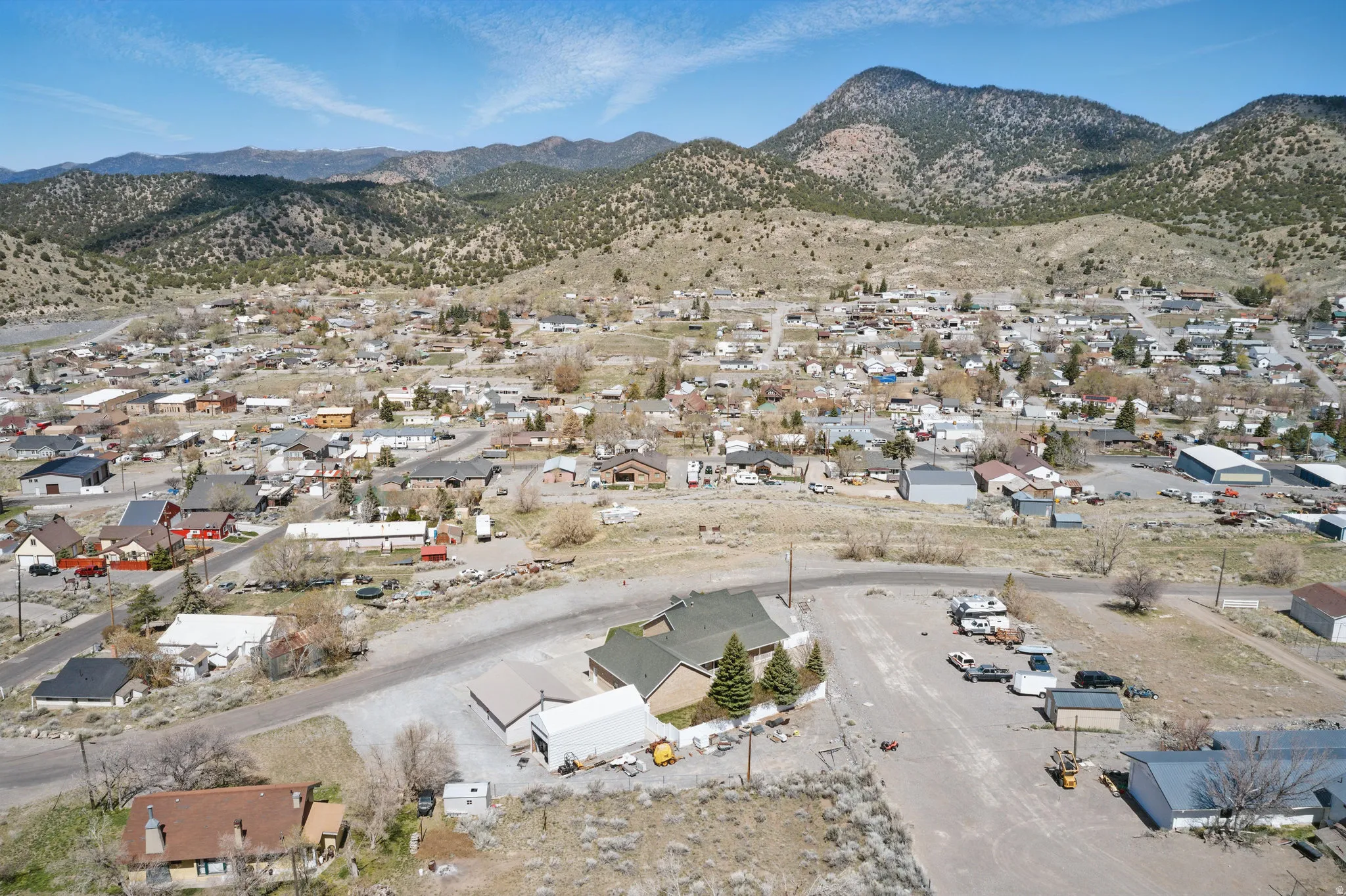 Expansive aerial perspective showcasing a town nestled within a mountainous landscape