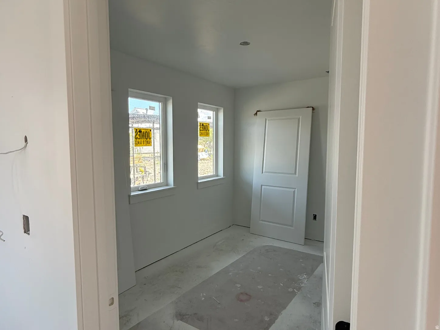 Recessed ceiling lighting, dual windows, and a panel-style barn door