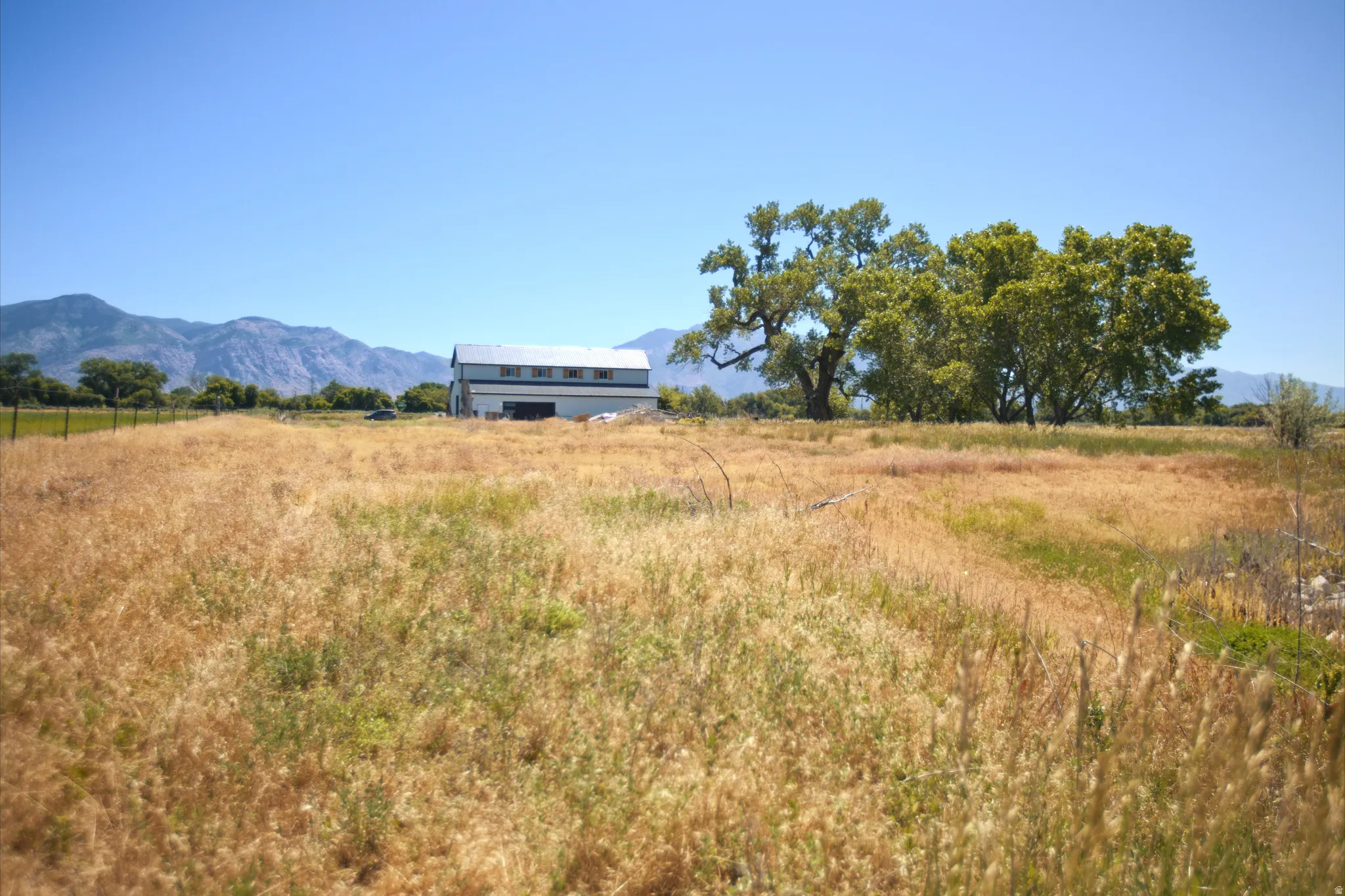 Expansive open land with a backdrop of distant mountains