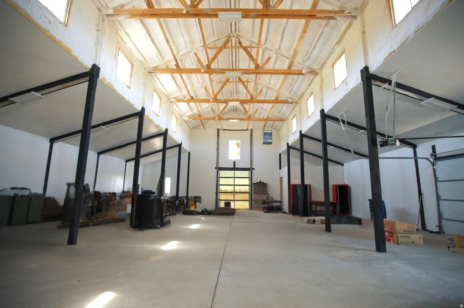 Spacious interior with exposed wood beam vaulted ceilings and multiple clerestory windows