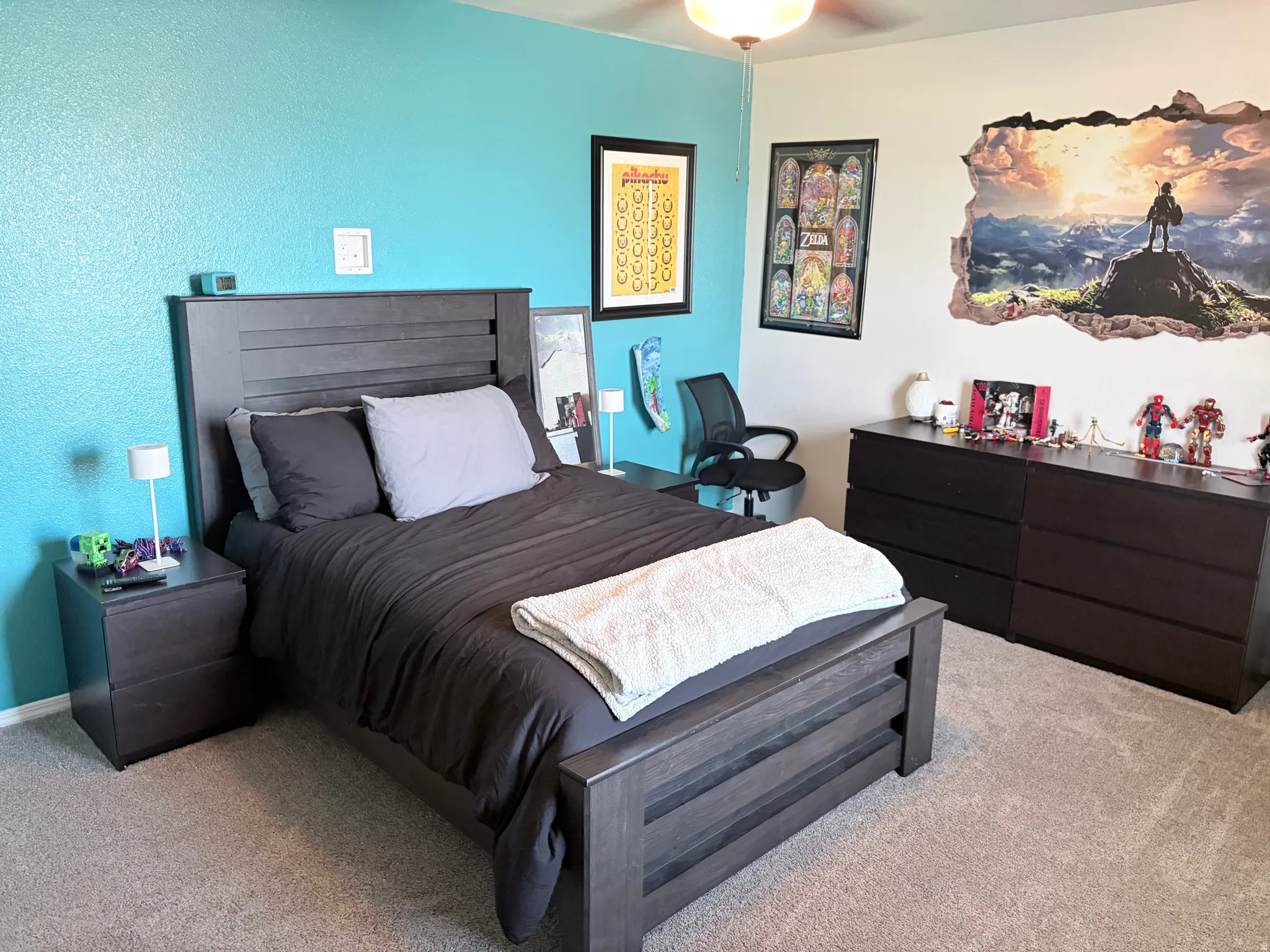 Carpeted room featuring a ceiling fan with light fixture, two-tone wall paint, and ample space for furnishings