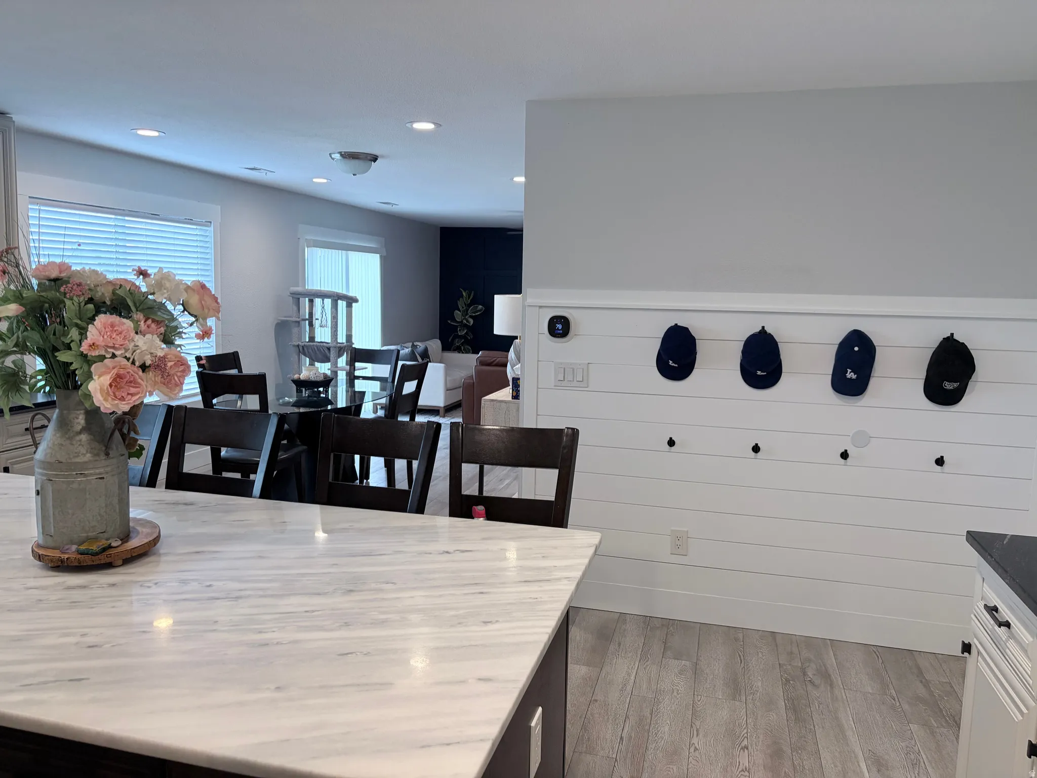 Open-concept interior featuring light wood-finish flooring and recessed lighting