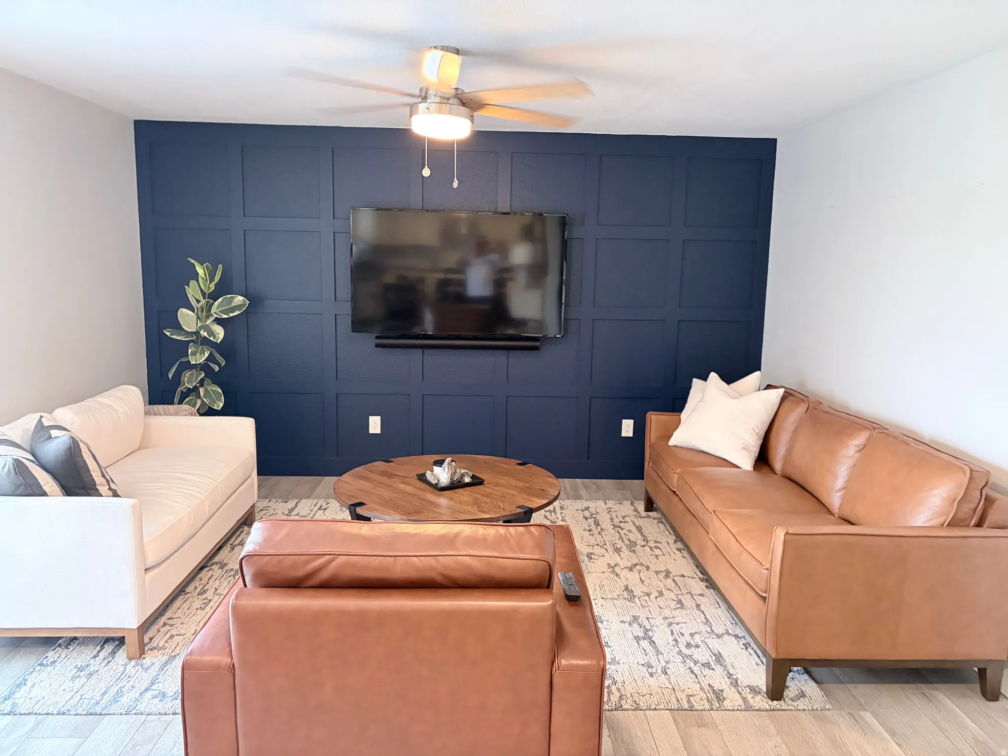 Accent wall with geometric paneling and mounted television
