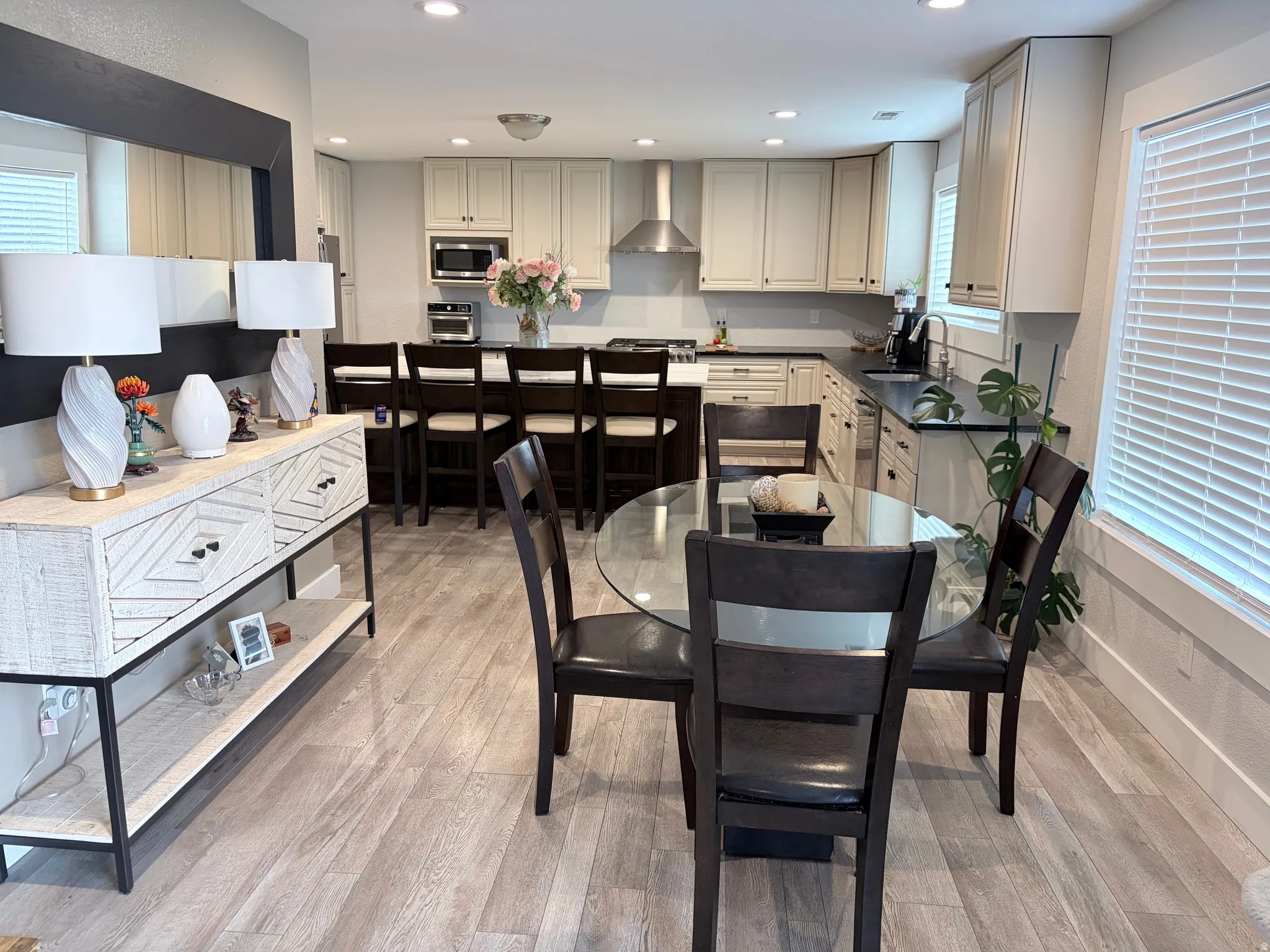 Open-concept kitchen and dining area featuring light wood-finish flooring