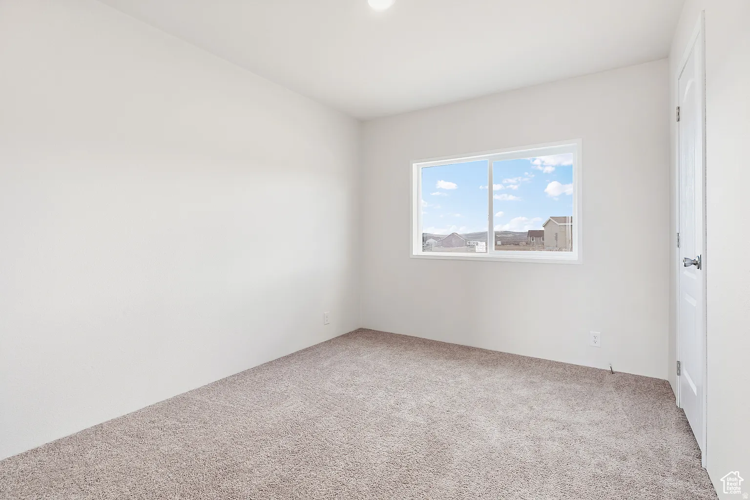 Neutral wall finishes and light-toned carpeting create a bright interior