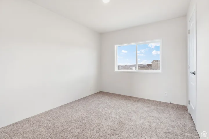 Neutral wall finishes and light-toned carpeting create a bright interior