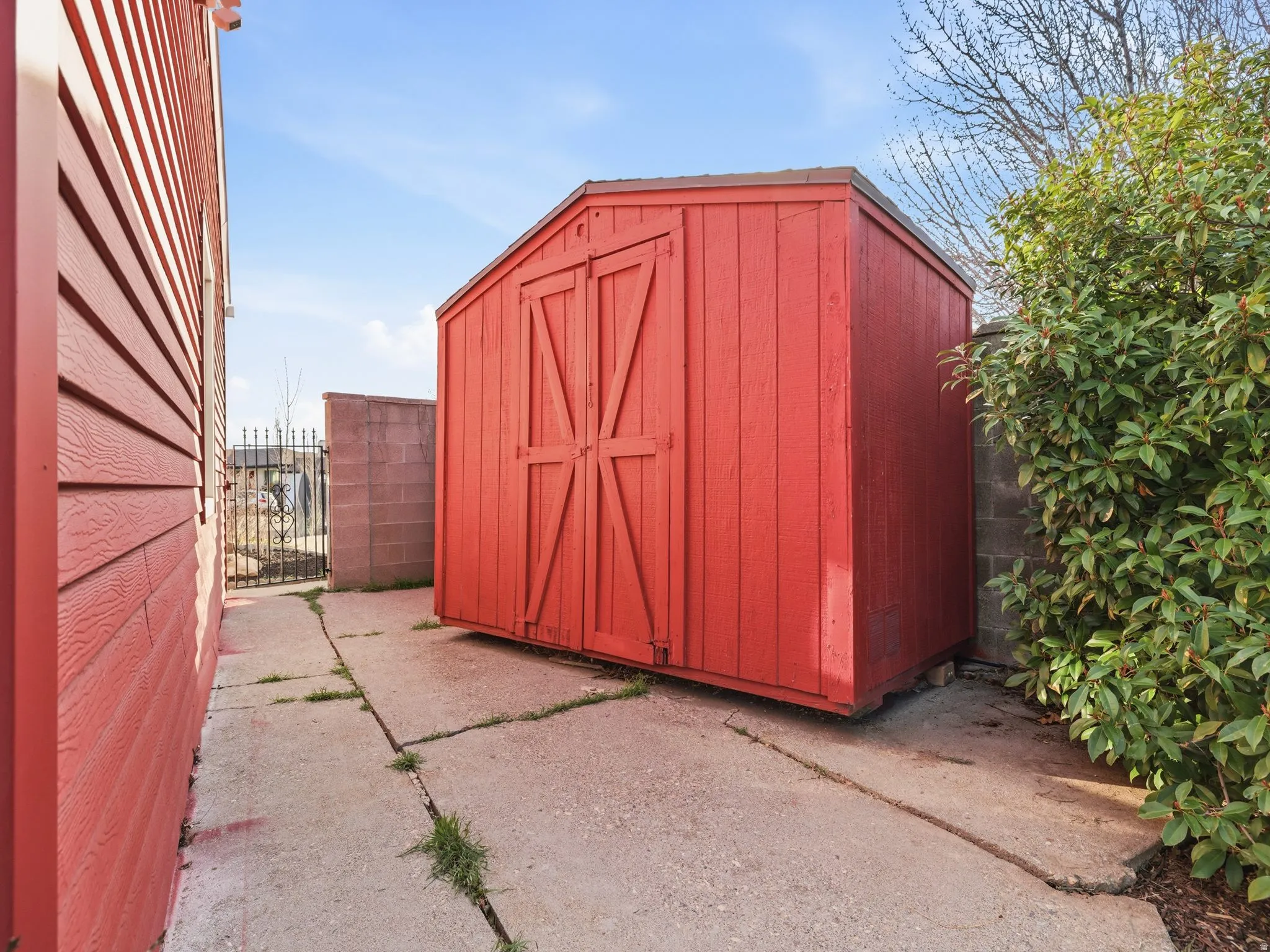 Freestanding red storage shed with double barn-style doors