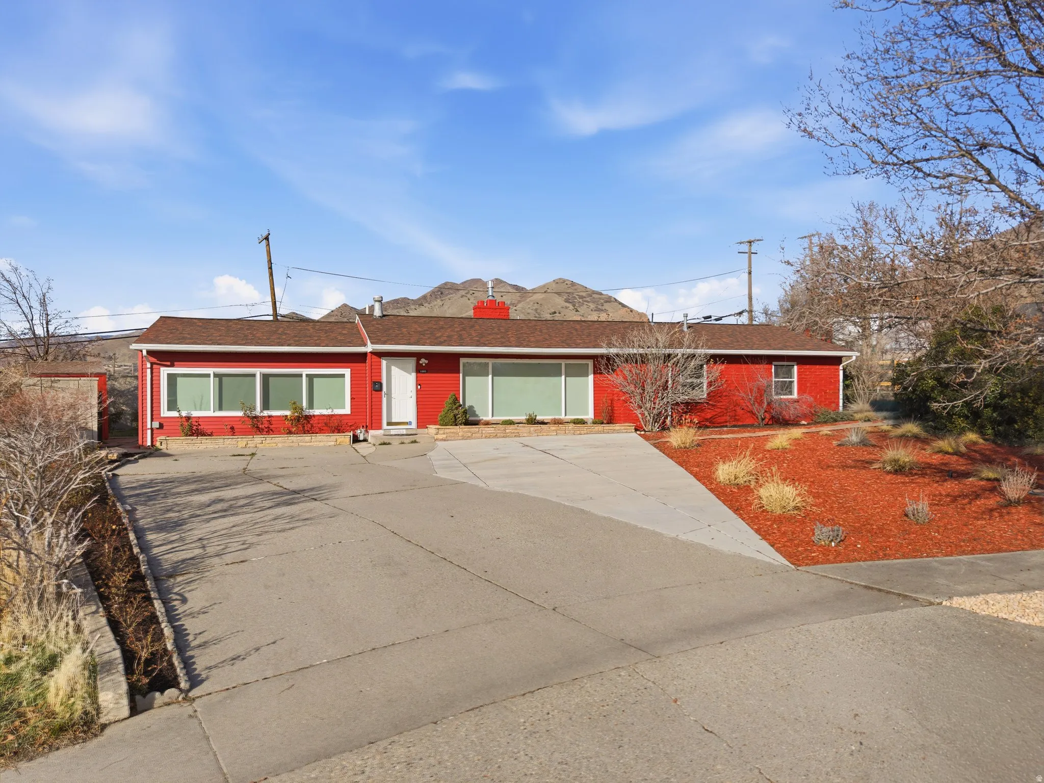 Ranch-style exterior with red siding and white trim