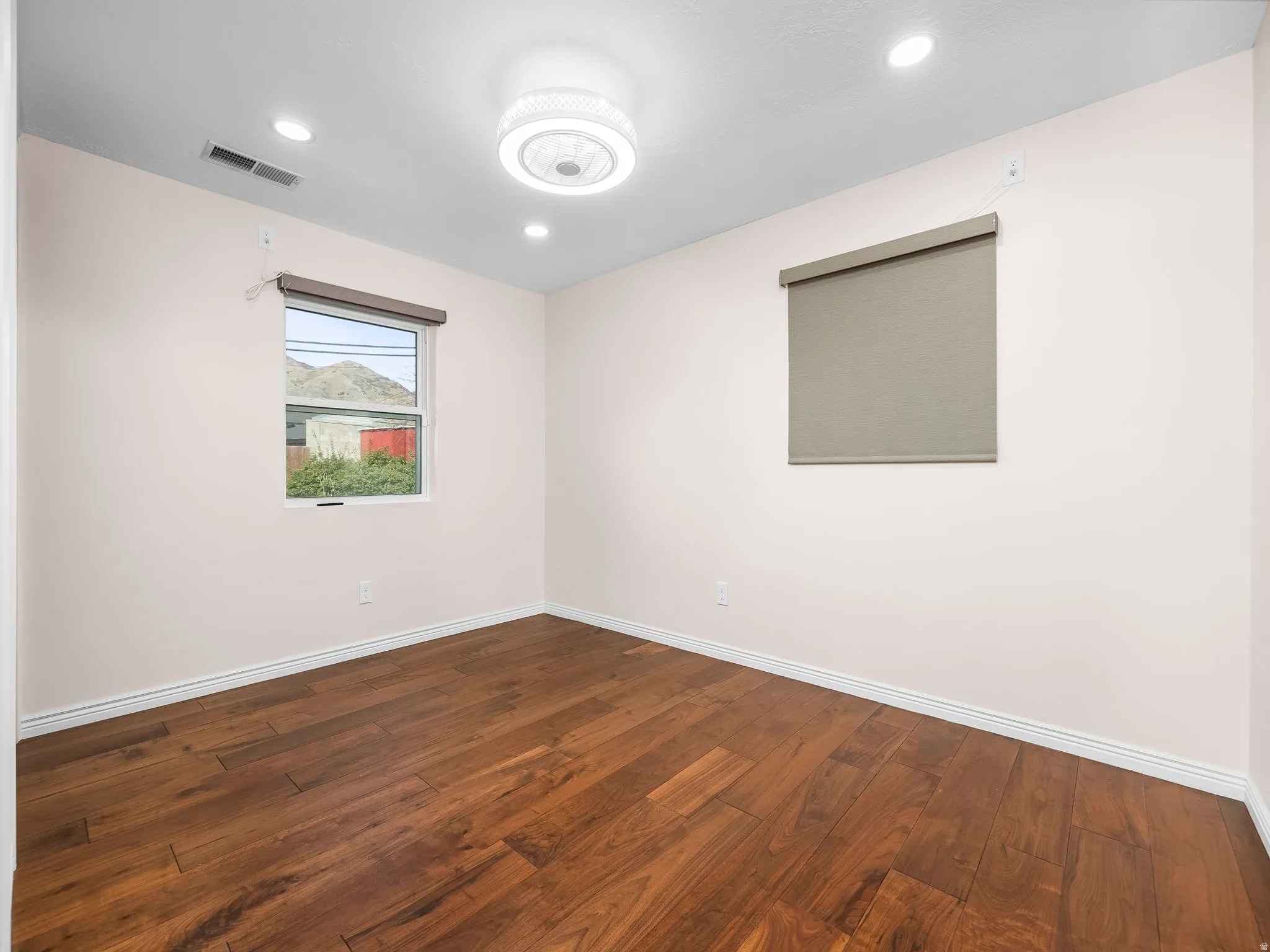 Room featuring rich wood-finish flooring and recessed lighting