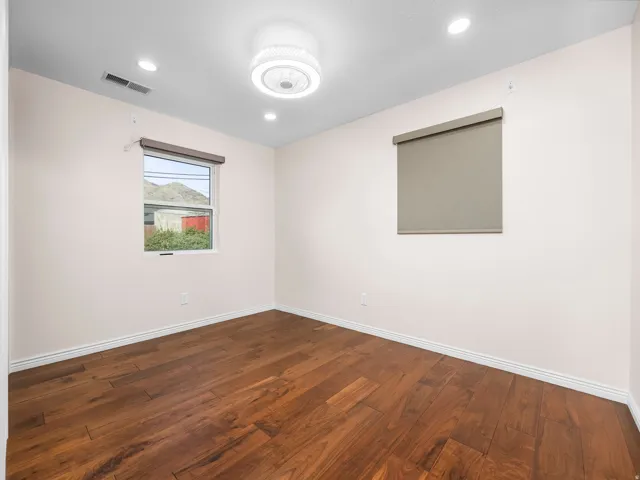 Room featuring rich wood-finish flooring and recessed lighting