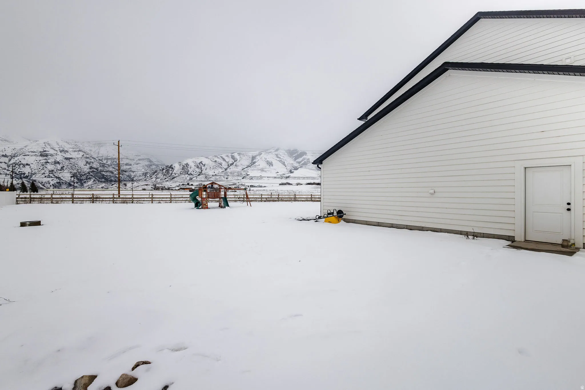 White siding exterior with a black-trimmed roofline