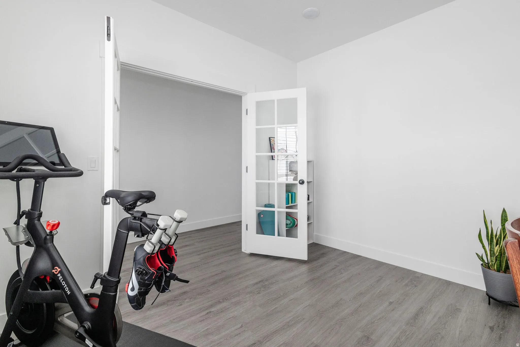Interior room featuring wood-finish flooring and white walls