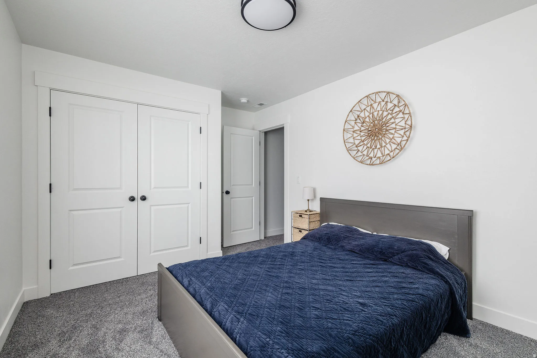 White walls complement the grey carpeting throughout this room