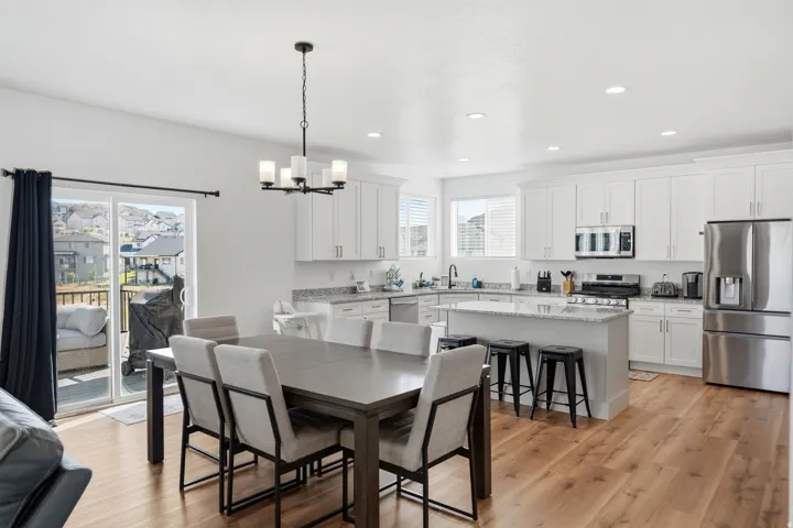 Open-concept kitchen and dining area with wood-finish flooring