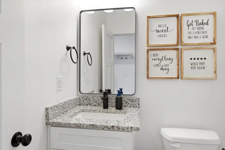 Vanity with a granite countertop and an undermount sink