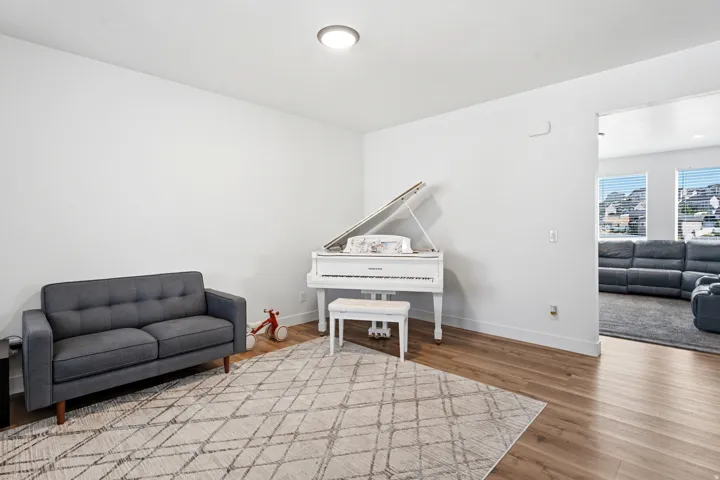 Bright interior space with wood-finish flooring and a flush-mount ceiling light