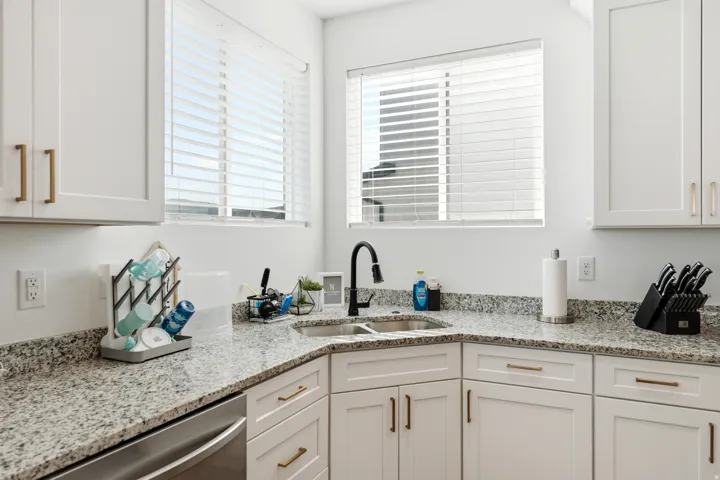 Corner kitchen sink with a matte black gooseneck faucet
