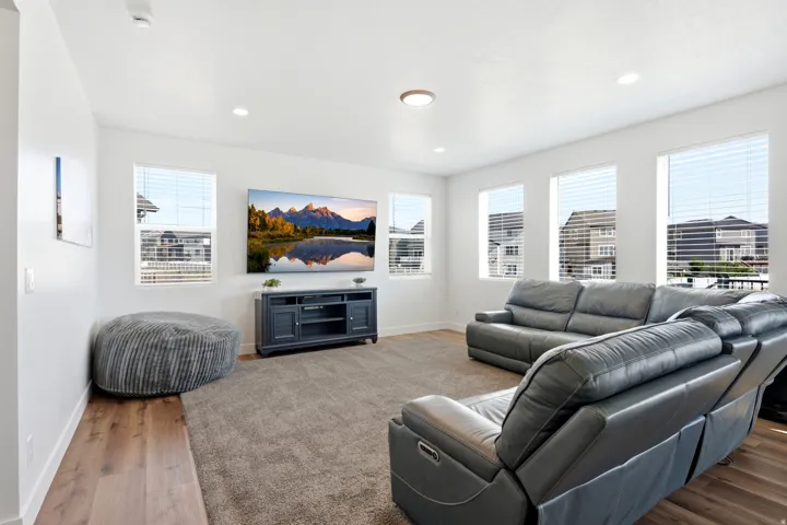 Bright living area featuring recessed lighting and a central flush-mount fixture