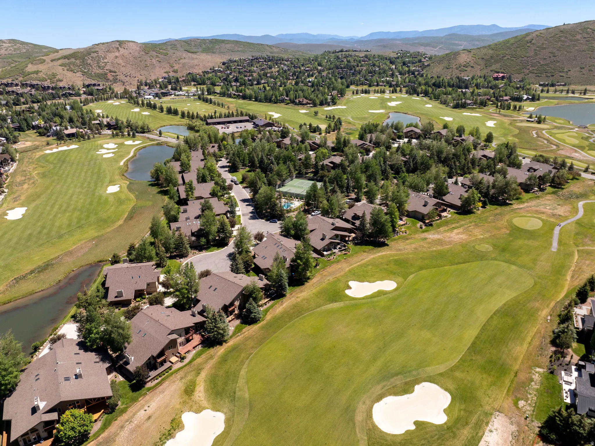 Expansive golf course property featuring multiple fairways, sand traps, and water features
