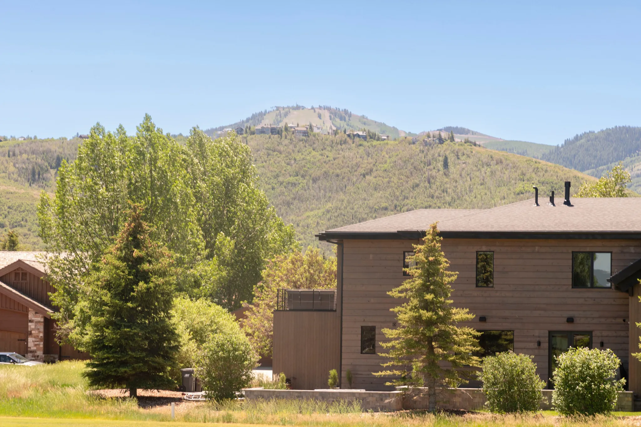 Exterior featuring horizontal siding, a gabled roofline, and multiple windows