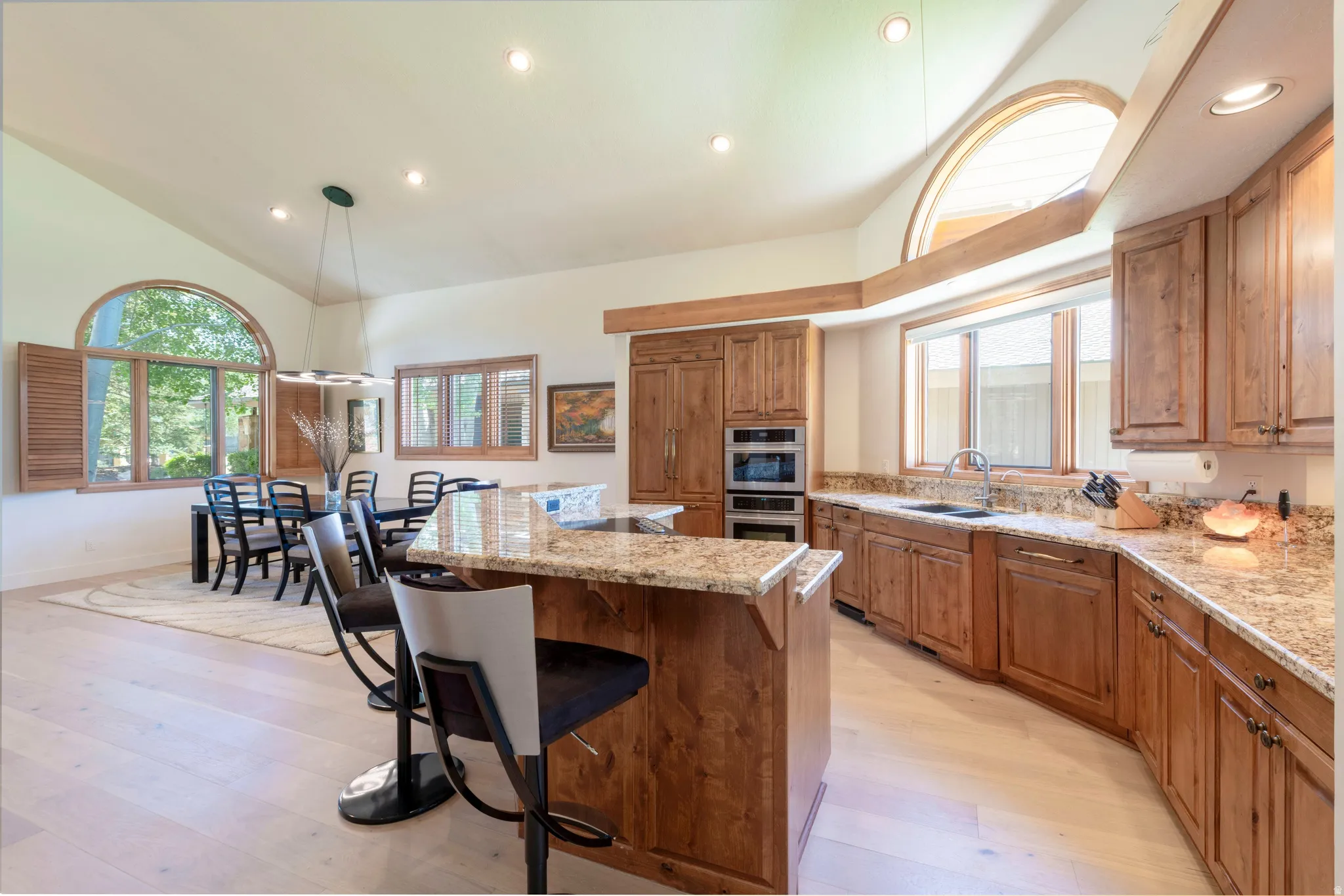 Kitchen featuring wood cabinetry, granite countertops, and stainless steel built-in appliances