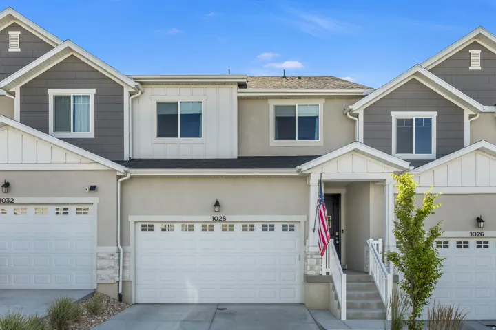 Modern townhome exterior featuring an inviting covered porch entry