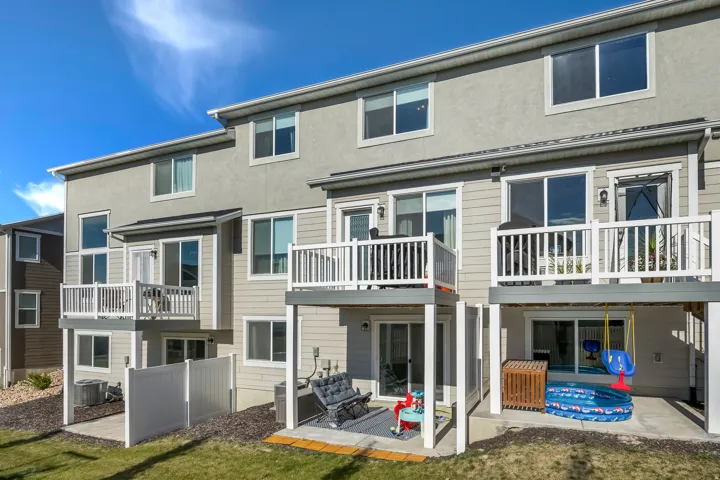 Multi-level townhome exterior featuring private balconies and ground-level patios