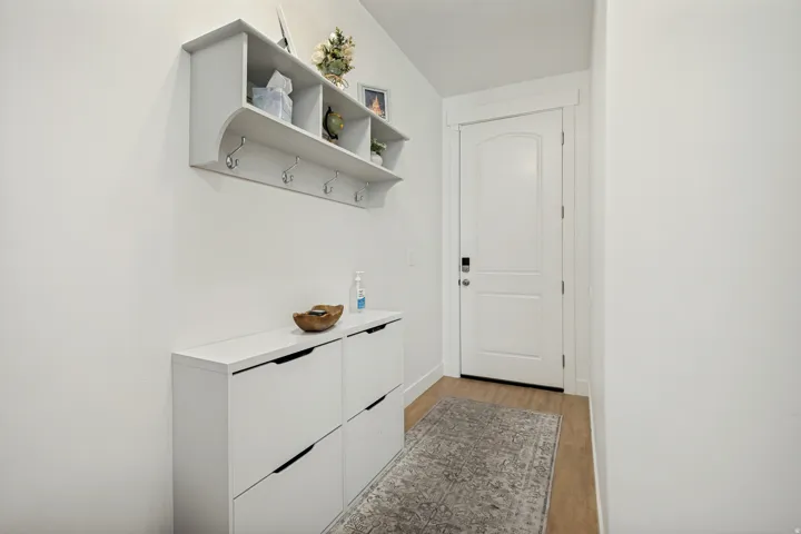 Entryway featuring light wood-finish flooring and a white paneled door