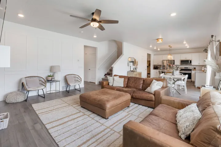 Open-concept living space featuring wood-finish flooring and recessed lighting