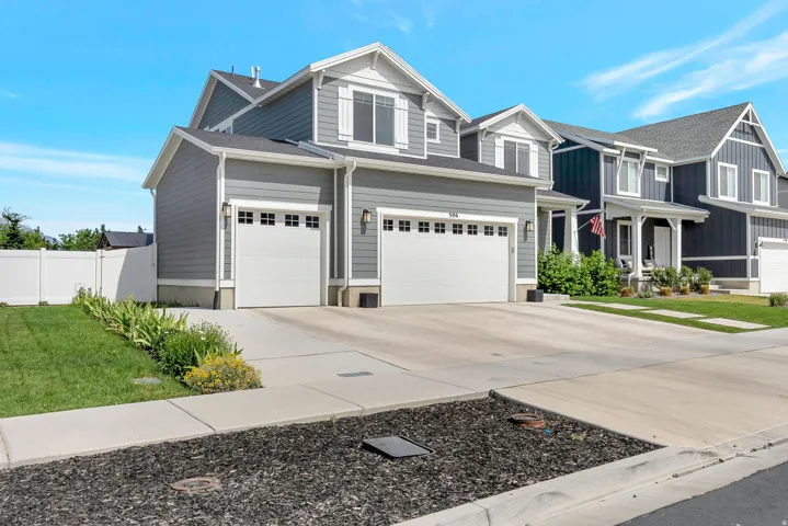 Contemporary gray residence featuring white trim and multiple gables