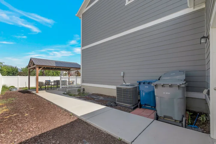 Covered patio with a metal roof and white railing