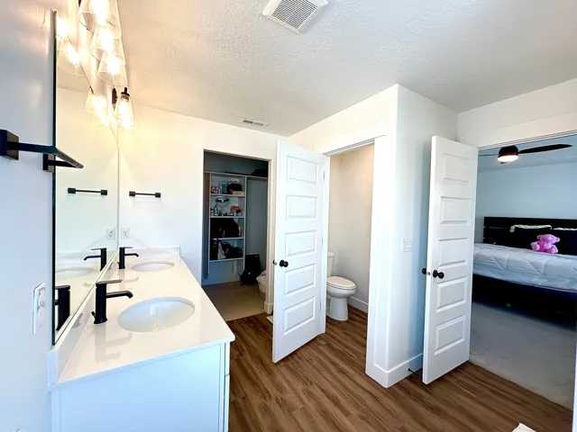 Dual vanity with white countertops, undermount sinks, and matte black fixtures