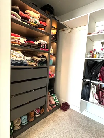 Custom closet system featuring built-in drawers and shelving