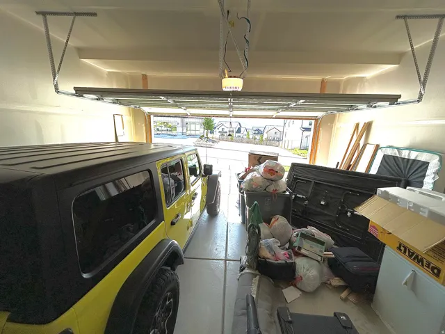 Attached garage featuring a concrete floor and a garage door opener