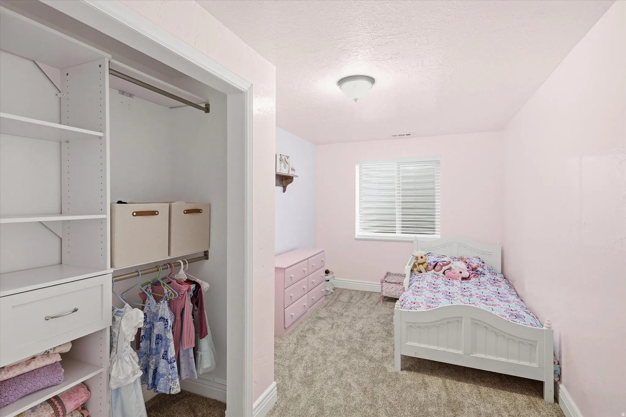 Room featuring soft wall color, a window with blinds, and neutral-toned carpeting