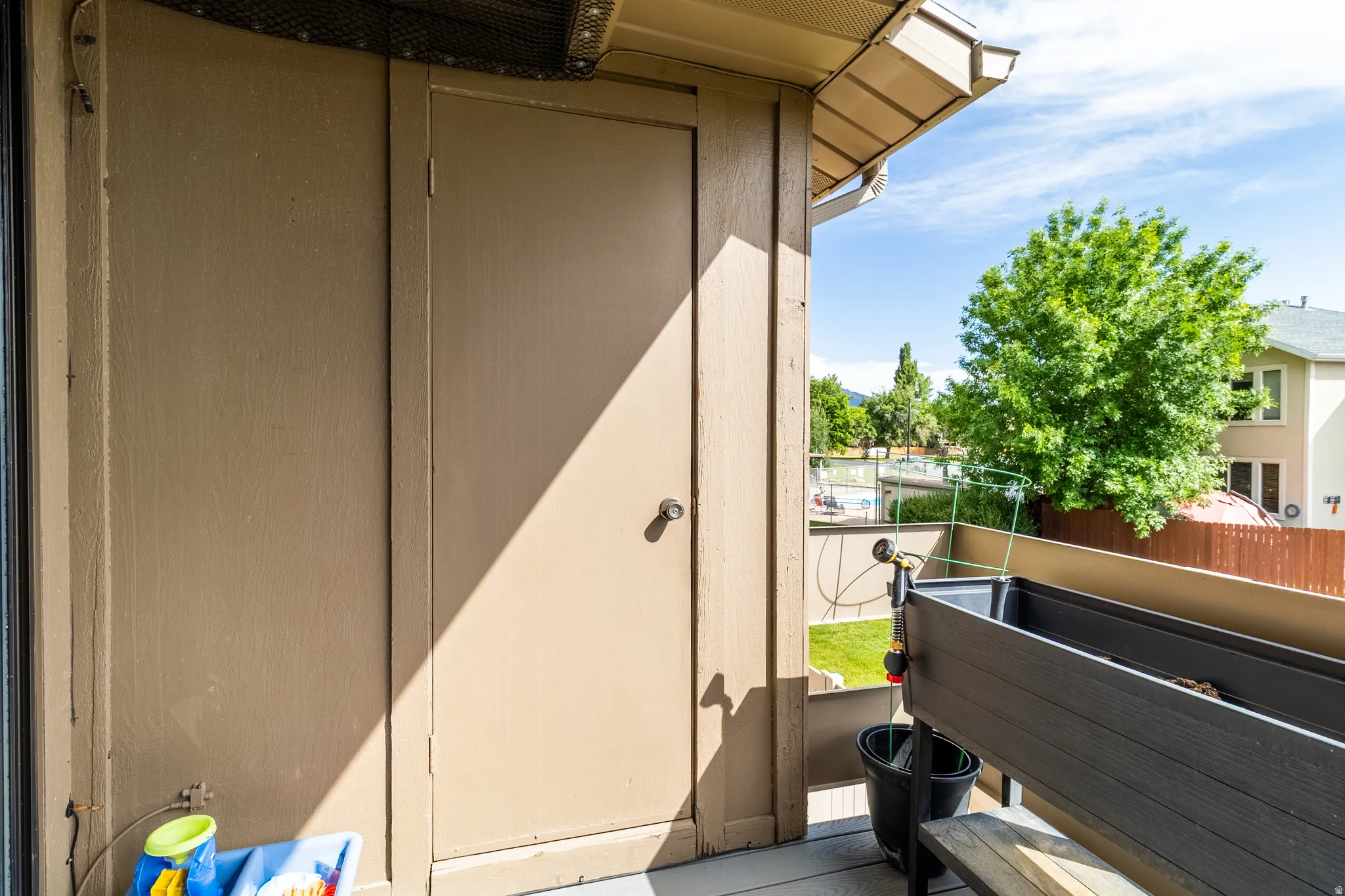 Outdoor balcony featuring a built-in storage closet with a single-panel door, and a perimeter railing