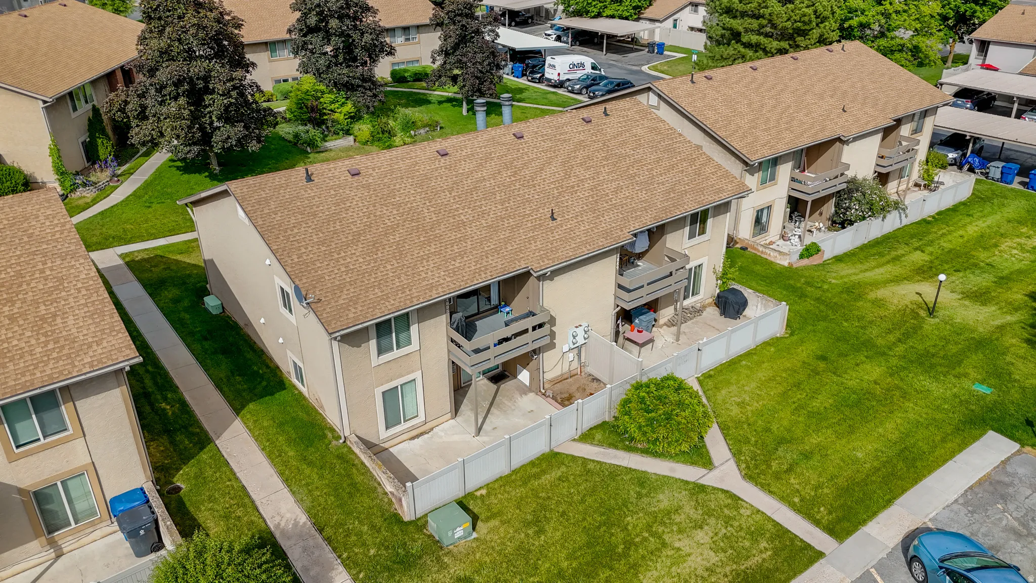 Residential complex with tan siding and brown shingle roofs