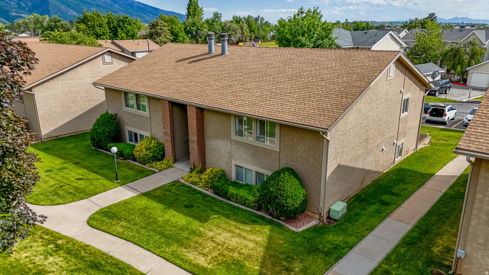 Two-story stucco building with a warm brown roof