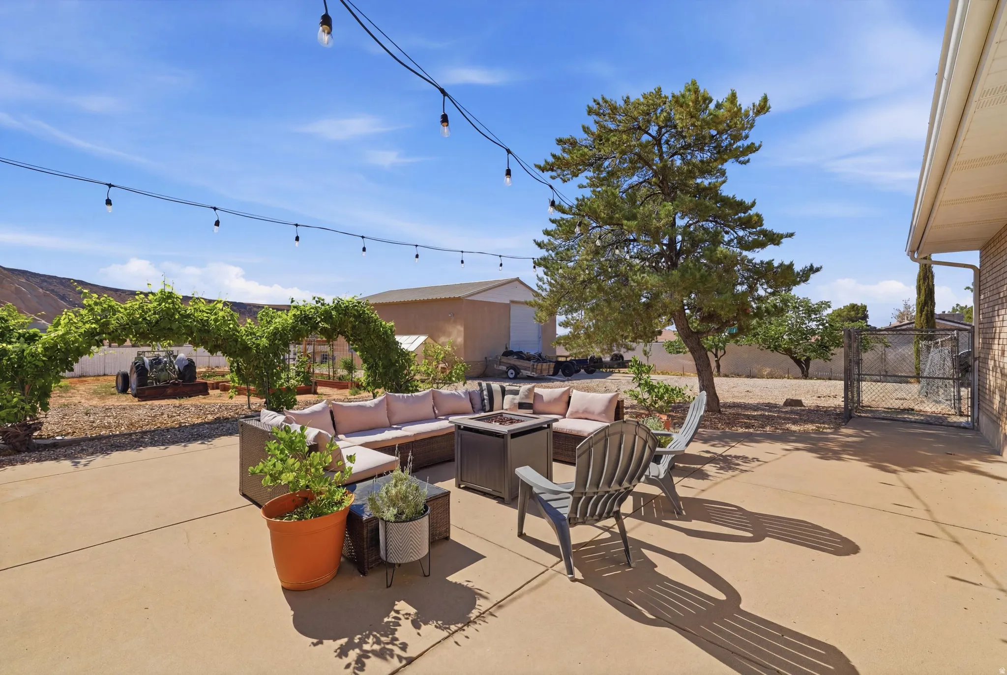 Expansive concrete patio area with string lighting overhead